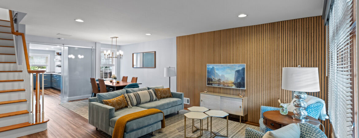 Bright and modern living room with wood accents, stylish furniture, and natural light.