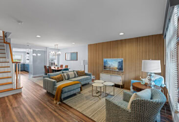 Bright and modern living room with wood accents, stylish furniture, and natural light.