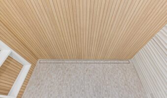 Bright modern interior with wooden ceiling and tiled floor, showcasing contemporary home renovation.