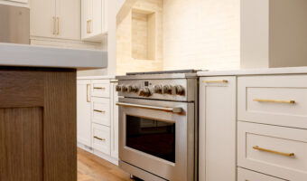 Modern kitchen with white cabinets and stainless steel stove for home renovation projects.