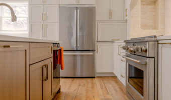 Modern kitchen with stainless steel appliances and white cabinetry for home renovation projects.
