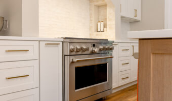 Modern kitchen with white cabinetry and stainless steel stove for home renovation projects.