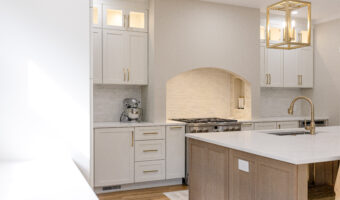 Bright modern kitchen with white cabinets, marble countertops, and gold fixtures, perfect for home r.
