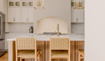 Modern kitchen with white cabinets, wooden accents, and a spacious island for home renovation projec.