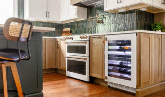 Modern kitchen with wooden cabinets, green backsplash, and wine cooler under the counter.