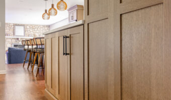 Bright modern kitchen with wooden cabinetry and pendant lighting, perfect for family gatherings and.
