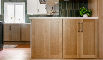 Beautiful kitchen with natural wood cabinets and green tile backsplash, showcasing modern home renov.