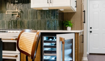 Modern kitchen with custom cabinetry and wine fridge under the "The Rooted Kitchen" theme.